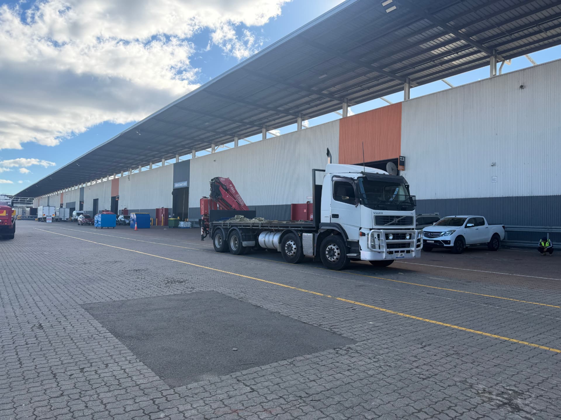 Everest Transport crane truck parked beside a large industrial warehouse